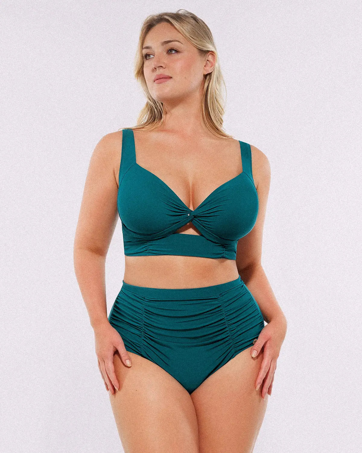 Model wearing twist-front deep teal bikini set with high-waisted tummy control bottoms