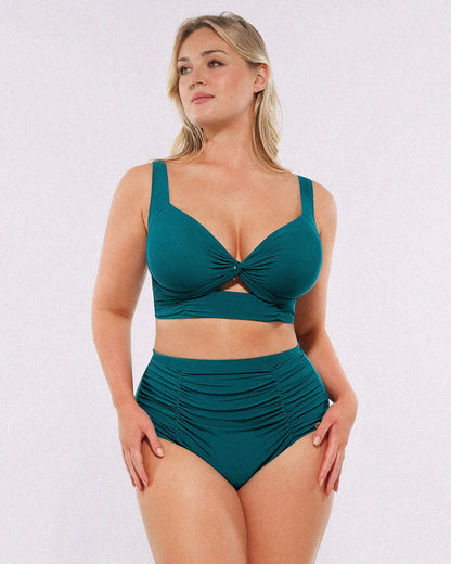 Model wearing twist-front deep teal bikini set with high-waisted tummy control bottoms