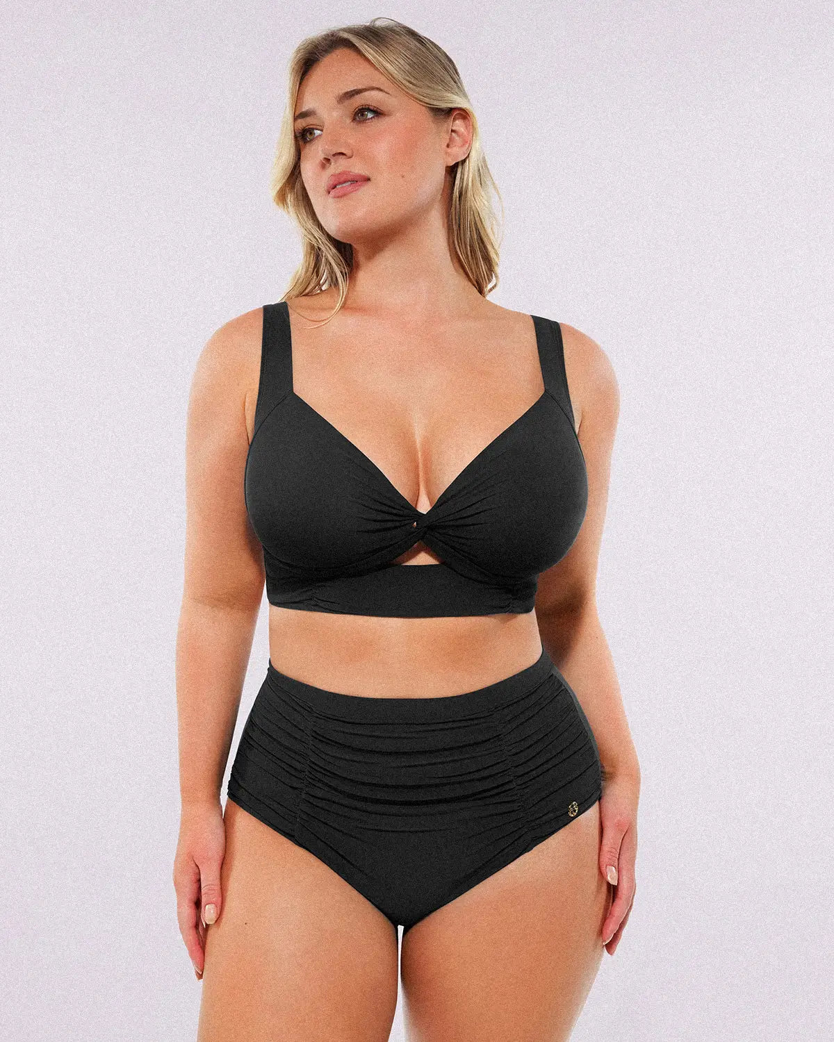 Model wearing twist-front black bikini set with high-waisted tummy control bottoms