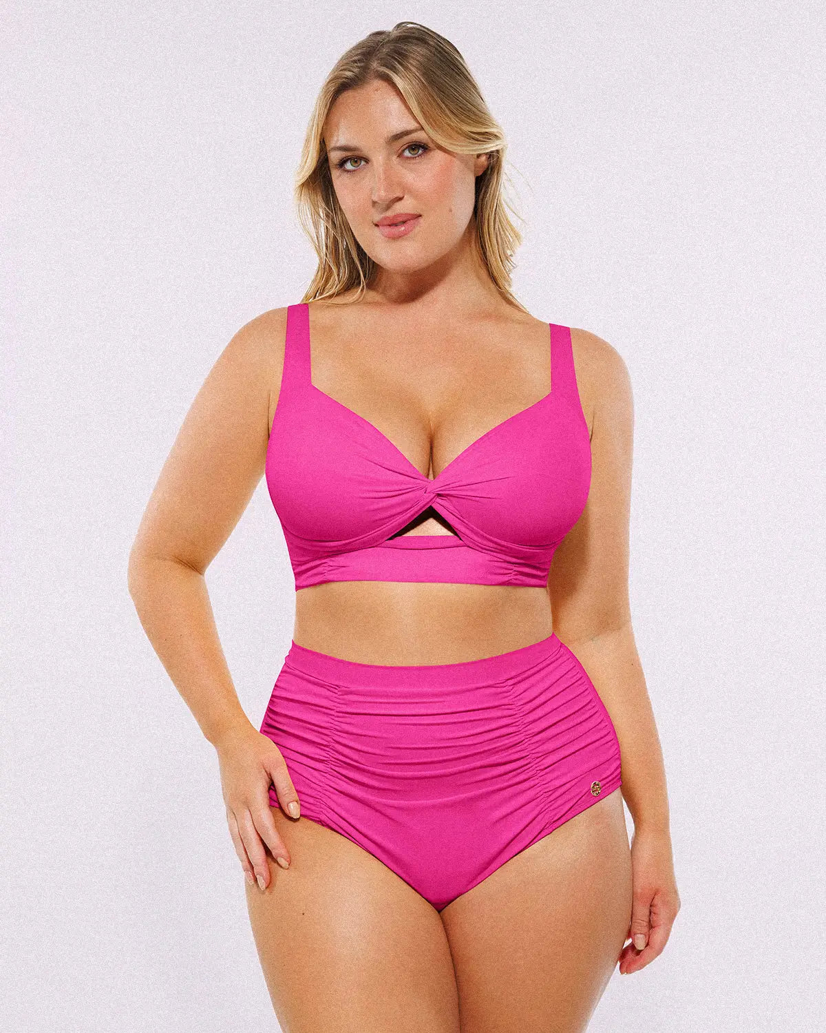 Model wearing twist-front fuchsia bikini set with high-waisted tummy control bottoms