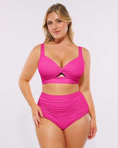Model wearing twist-front fuchsia bikini set with high-waisted tummy control bottoms